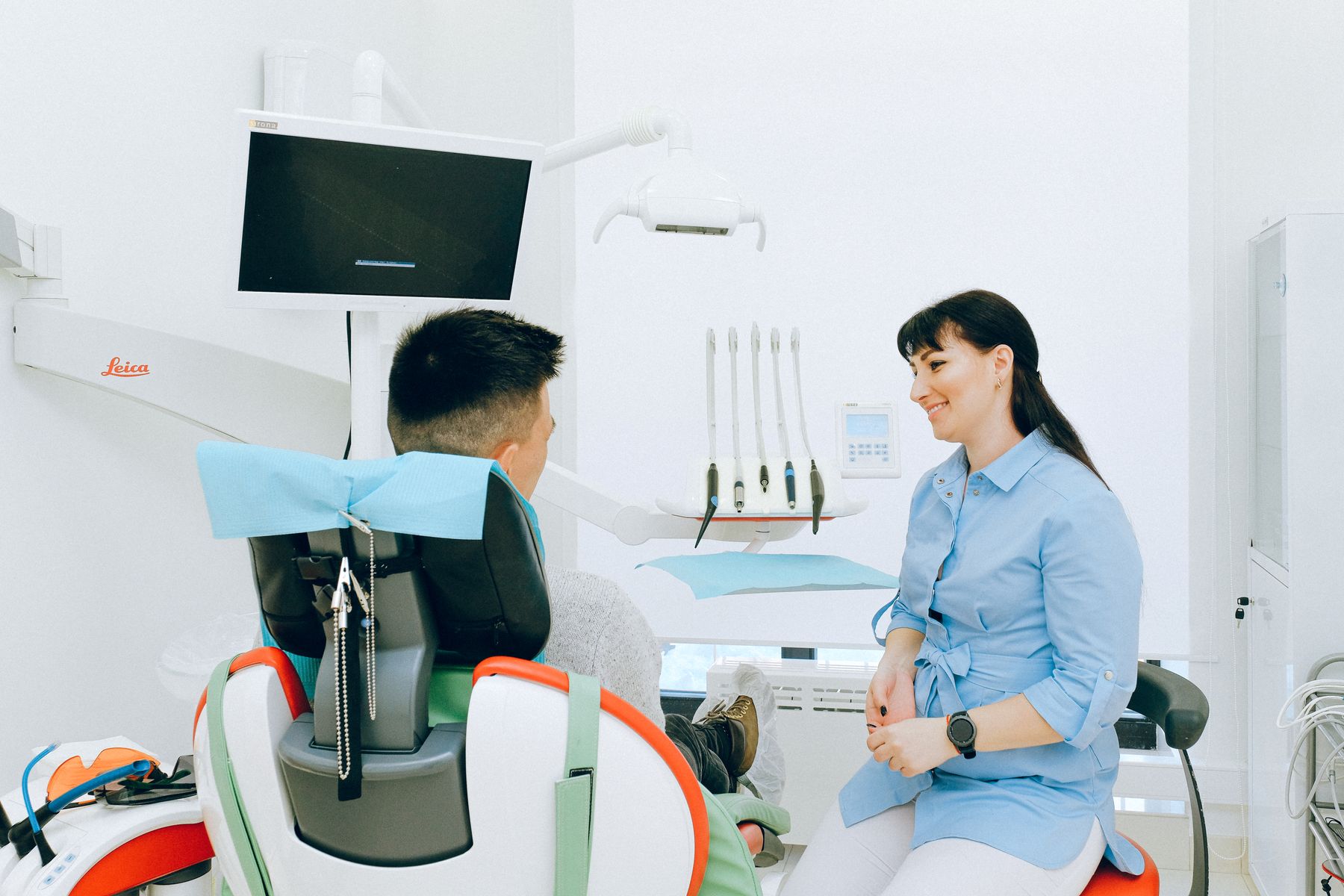 A dentist and patient talking during a consultation